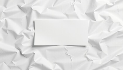 A white piece of paper positioned over a textured surface that appears to be crumpled white paper, creating a layered effect.