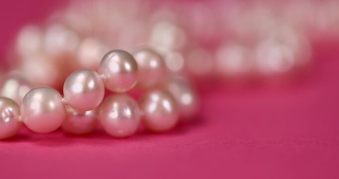 natural unpolished irregular shaped pearls from a marine mollusk used in the manufacture of women's jewelry beads, a necklace made from natural pearl beads strung on a string