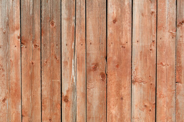 A wooden fence with a red background