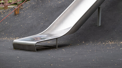 Metal playground slide on rubber safety surface