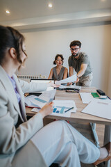 Young couple discussing loan options with a bank advisor in a professional setting. The meeting...