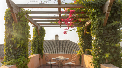 Romantic outdoor seating area with a pergola covered in lush green vines and pink flowers