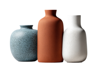 Three textured ceramic vases in muted colors
