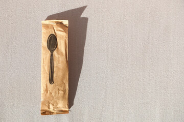 Eco-Friendly Disposable Wooden Spoon in Paper Packaging, Perfect for Sustainable Dining Environmentally Conscious Events, Promoting Green Living Choices. Copy space