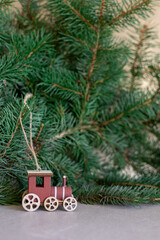 Wooden toy train decoration with pine branches
