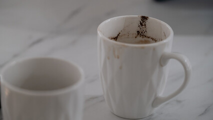 Dirty white coffee cup with coffee stains