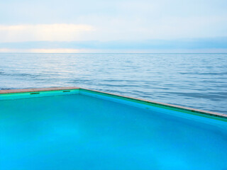 Swimming pool with clear water and view on ocean