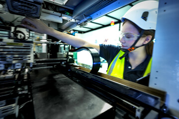 In an Industry 4.0 smart factory, an engineer uses a tablet to run an AI machine vision algorithm on a collaborative robot cobot, optimizing production via a real time digital twin.