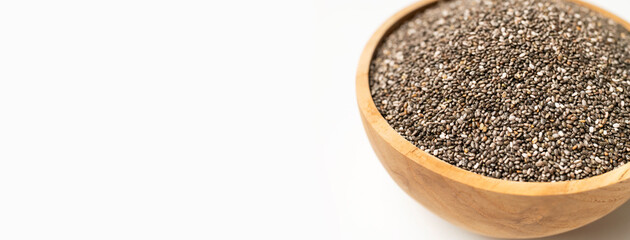 Chia seeds in wooden bowl on white background. Healthy seeds for desserts, healthy eating, antioxidant, and superfood rich in omega-3 fats, protein, vitamins and minerals