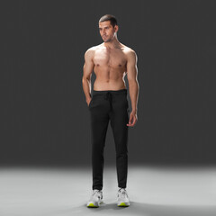 Fit young man wearing sportswear standing in studio