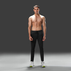 Fit young man wearing sportswear standing in studio