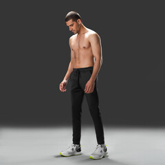 Fit young man wearing sportswear standing in studio