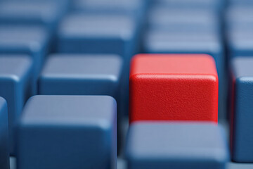 Fototapeta premium A close-up of a keyboard featuring multiple blue keys, with one red key standing out prominently among them.