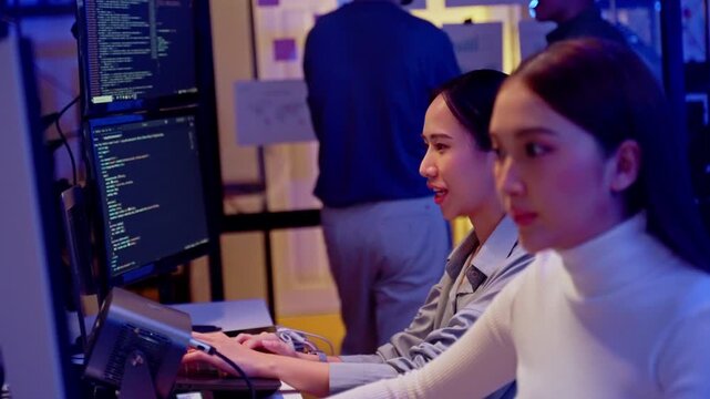 Asian software engineer or programmer team working late in development office,problem solving or algorithm of ai assistant helping for work.software developer,digital technology security concept