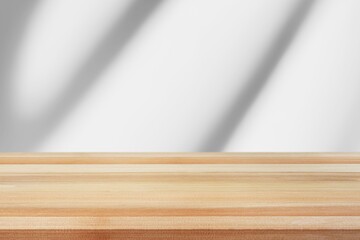 Empty wooden desk with white background with shadow