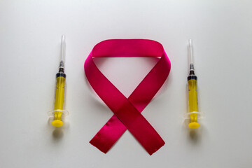 World AIDS Day emblem and two yellow syringes. On a white background.