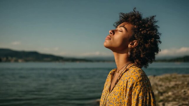 Embracing Serenity: A woman basks in the warm glow of sunlight by the tranquil lake, finding solace in the moment. A visual ode to peace and self-discovery