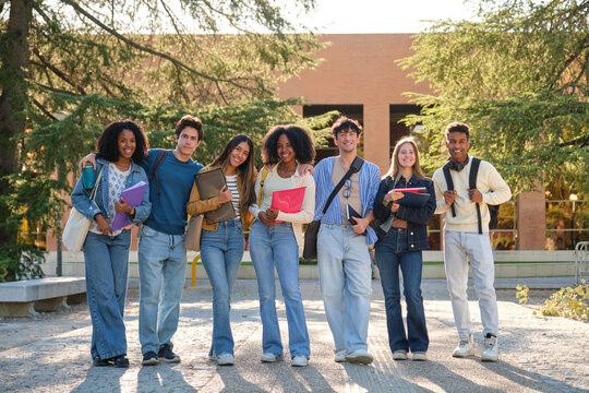 Group of diverse university students walking together on campus, representing friendship and education