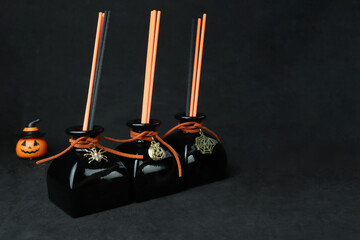 black luxury aroma scent reed diffuser glass bottle on black table to create mystery and luxury...