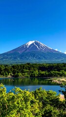 Majestic mountain vista with serene lake and greenery