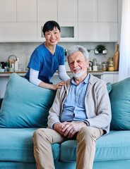 Fototapeta premium Doctor or nurse caregiver with senior man talking and having fun at home or nursing home