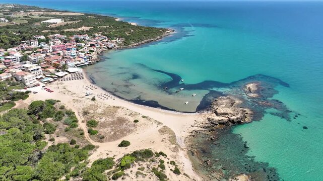 Aerial drone cinematic video of small seaside village and circular sandy beach of Arkoudi in Western Peloponnese, Ilia prefecture, Greece