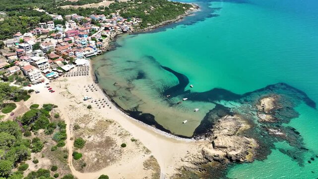 Aerial drone cinematic video of small seaside village and circular sandy beach of Arkoudi in Western Peloponnese, Ilia prefecture, Greece