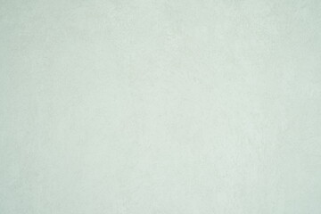A minimalist textured light gray wall surface with subtle patterns and a soft matte finish