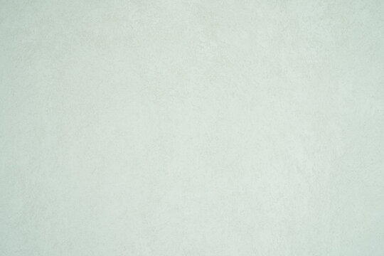 A minimalist textured light gray wall surface with subtle patterns and a soft matte finish