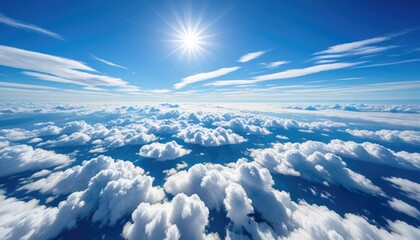 Fototapeta premium Bright sun shining above a fluffy cloudscape in a blue sky