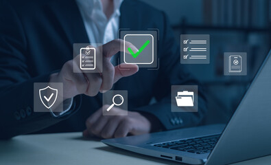 Businessman touching digital check mark icon with virtual data protection, security verification, and compliance checklist. Perfect for technology, cybersecurity, and business approval concepts.