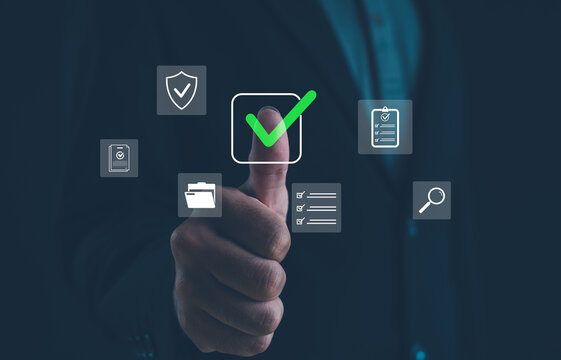 Businessman showing thumbs up with digital check mark icons symbolizing approval, data security, quality assurance, and document management in modern business technology concept.