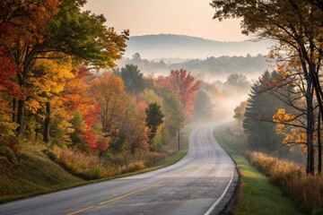 Obraz premium A winding country road lined with trees in peak fall colors
