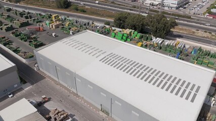 Miluot, Israel - 14 May 2025: Aerial view of the industrial zone's buildings and warehouses, showcasing a contrast of textures and tones in the landscape.