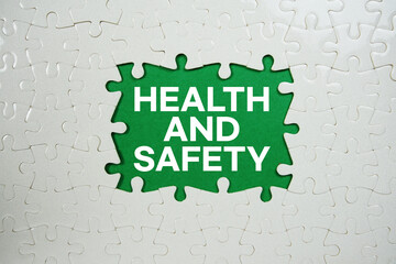 Jigsaw puzzle with a missing piece with "Health and Safety" on green background