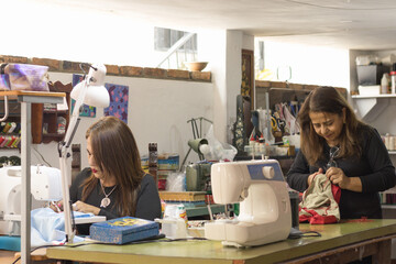 Women working in a busy textile sewing workshop