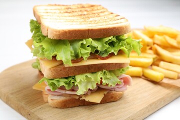 Tasty sandwich served with french fries on white table, closeup