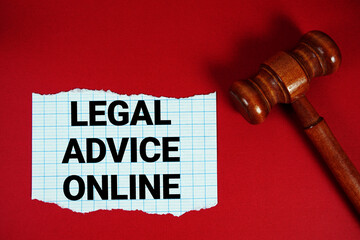 Legal Advice Online text written on rip paper with wooden judgment gavel on red background