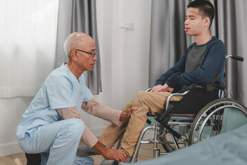 A mentally healthy young man with disability in a wheelchair being examined by doctor or physical...