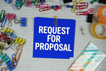 Request For Proposal text on stick note with stationery on concrete background