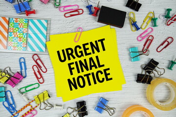 Urgent Final Notice text on stick note with stationery on concrete background