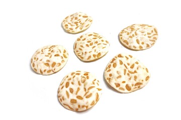 Keripik Tempe or Tempeh Chips isolated on white background with copy space. Traditional Indonesian food are made from soybeans mixed with rice flour then sliced ​​thinly. Suitable fot design element.
