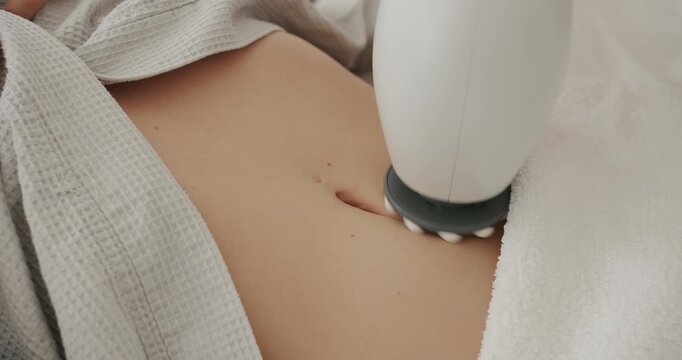 Beauty treatment rejuvenation procedure. Masseur makes apparatus anti cellulite massage in the cosmetology clinic. Beautiful woman getting anti cellulite and anti fat therapy in beauty salon.