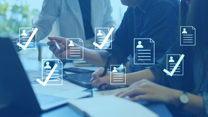 Business recruitment team in a meeting, using technology for candidate selection and employee hiring management.