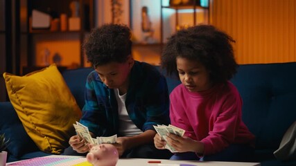 Happy African American siblings counting money, saving cash for their dream goal
