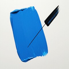 Vibrant blue paint stroke with a black brush on a clean white background