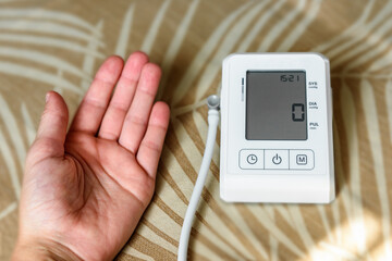 Measuring blood pressure with an automatic blood pressure monitor at home.