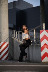 Woman posing on the road wearing fashionable clothes