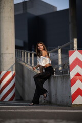 Woman posing on the road wearing fashionable clothes