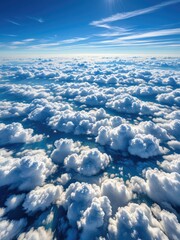 Aerial view of puffy white clouds, a blue sky, and sunshine